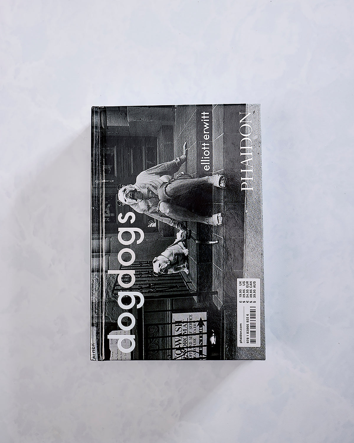Dogdogs photography book cover by Elliott Erwitt, showing a black-and-white street photograph with the title and Phaidon branding.