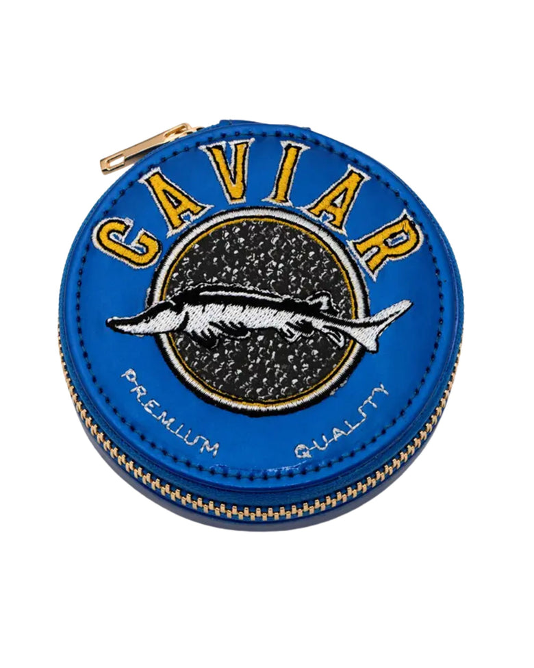 Blue round Caviar Daily Pill Case with a gold zipper and embroidered fish design.