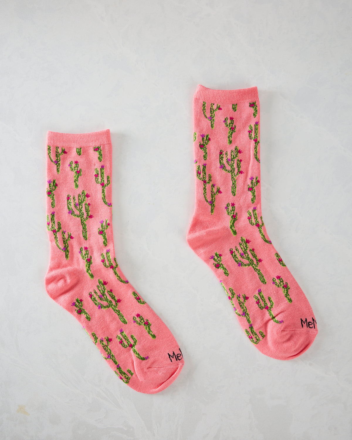 Pair of pink cactus-pattern crew socks displayed separately.