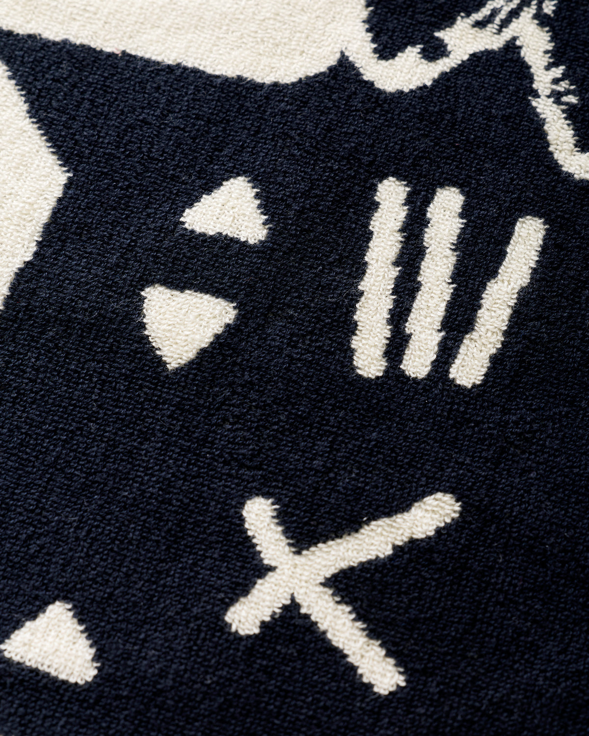 Close-up of the Lazy Cat hand towel showing the cat face pattern and textured weave.