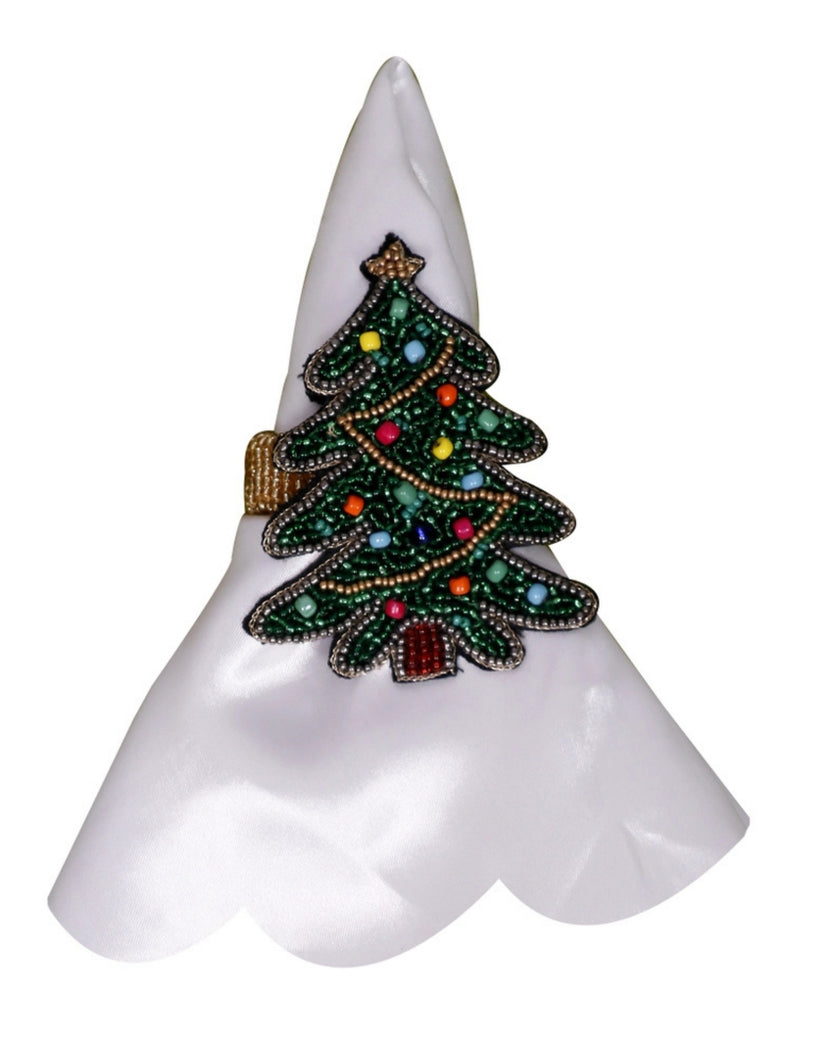 Beaded Christmas tree napkin ring displayed on a folded white napkin