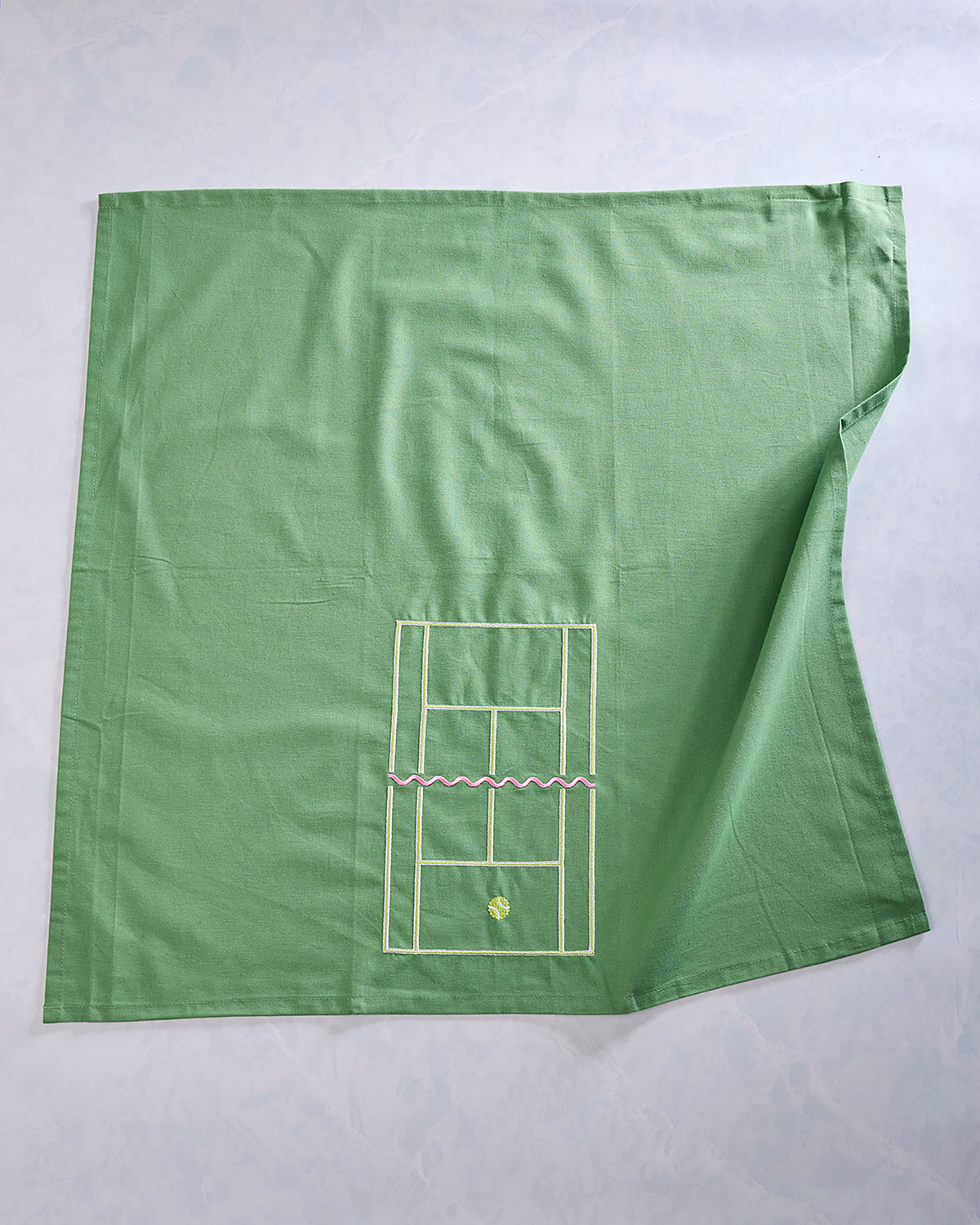 Full view of a green tea towel with a small embroidered tennis court diagram near the lower center.