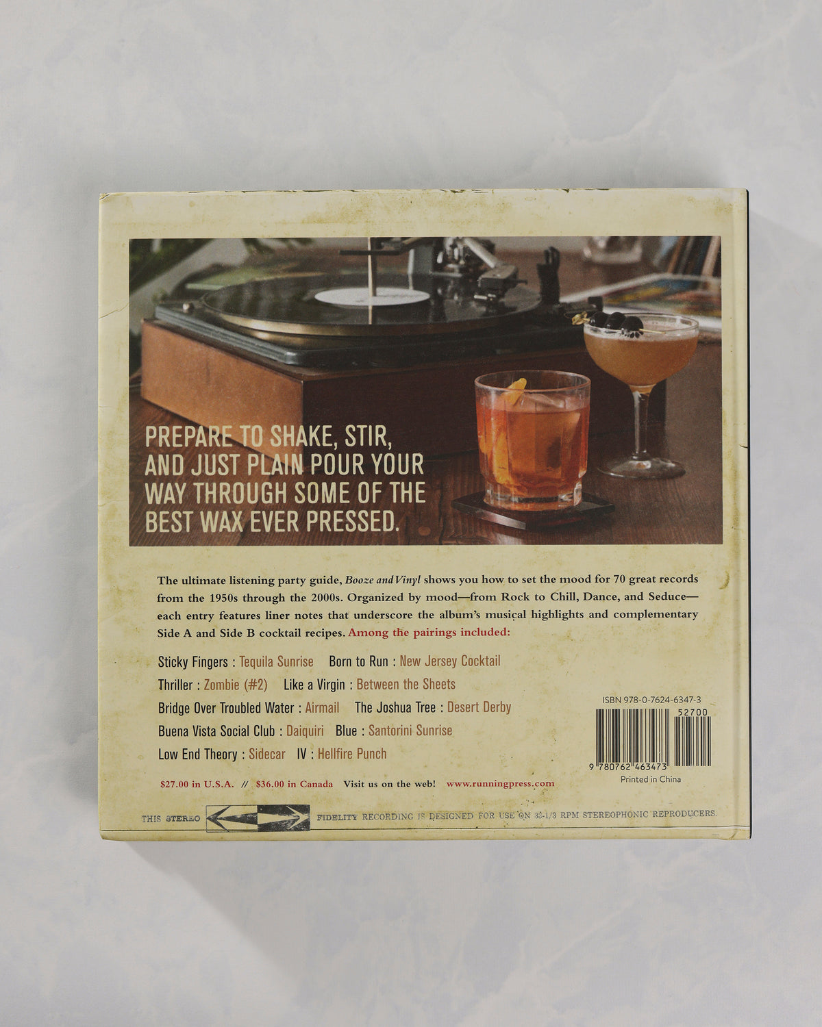 Back cover of Booze & Vinyl featuring a turntable, two cocktails, promotional text, a contents list, and a barcode.