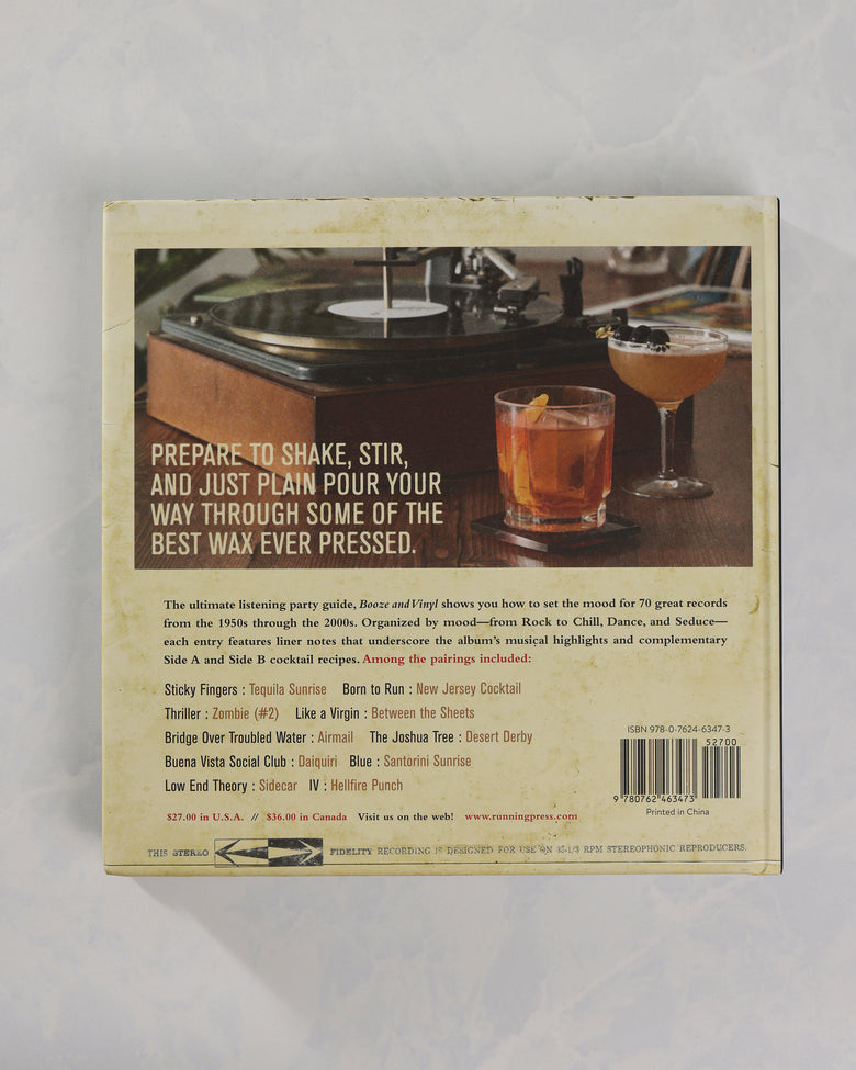 Back cover of Booze & Vinyl featuring a turntable, two cocktails, promotional text, a contents list, and a barcode.