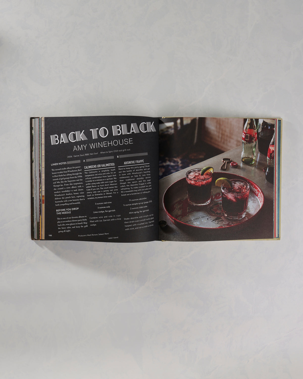 Open Booze & Vinyl book showing an Amy Winehouse entry beside a photograph of two drinks.
