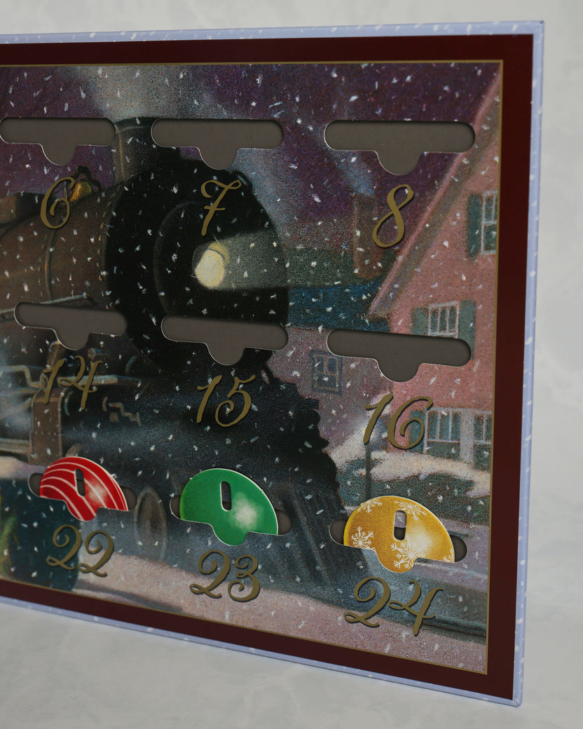 Close-up of the Polar Express countdown calendar showing numbered ornament pockets and several colored ornaments, including dates 6 through 8 and 22 through 24.
