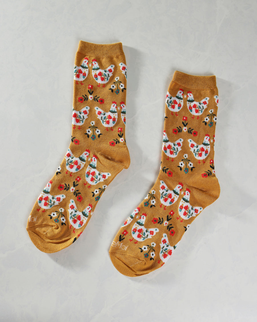 Mustard County Chick crew socks displayed side by side, with repeating chickens and flowers.