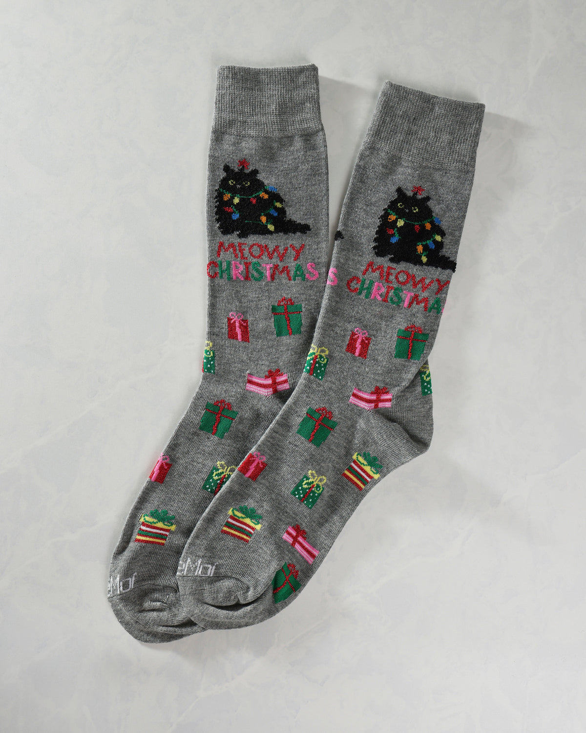 Pair of gray crew socks with Christmas tree cat designs, gifts, and “MEOWY CHRISTMAS” lettering