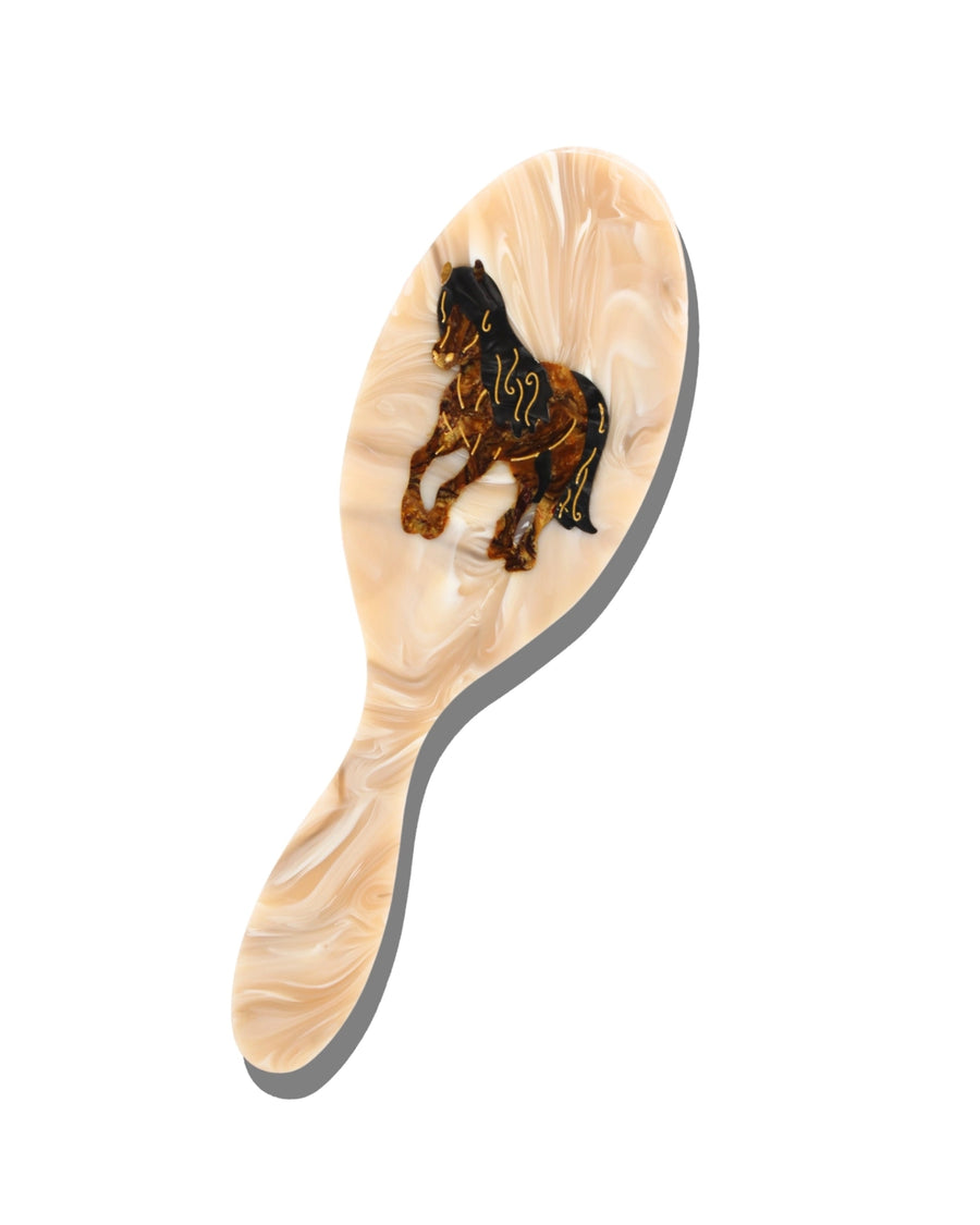 Ivory hair brush with a horse-shaped decorative insert on the back