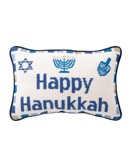 Needlepoint pillow reading “Happy Hanukkah,” with blue Jewish symbols and a blue-and-white border.