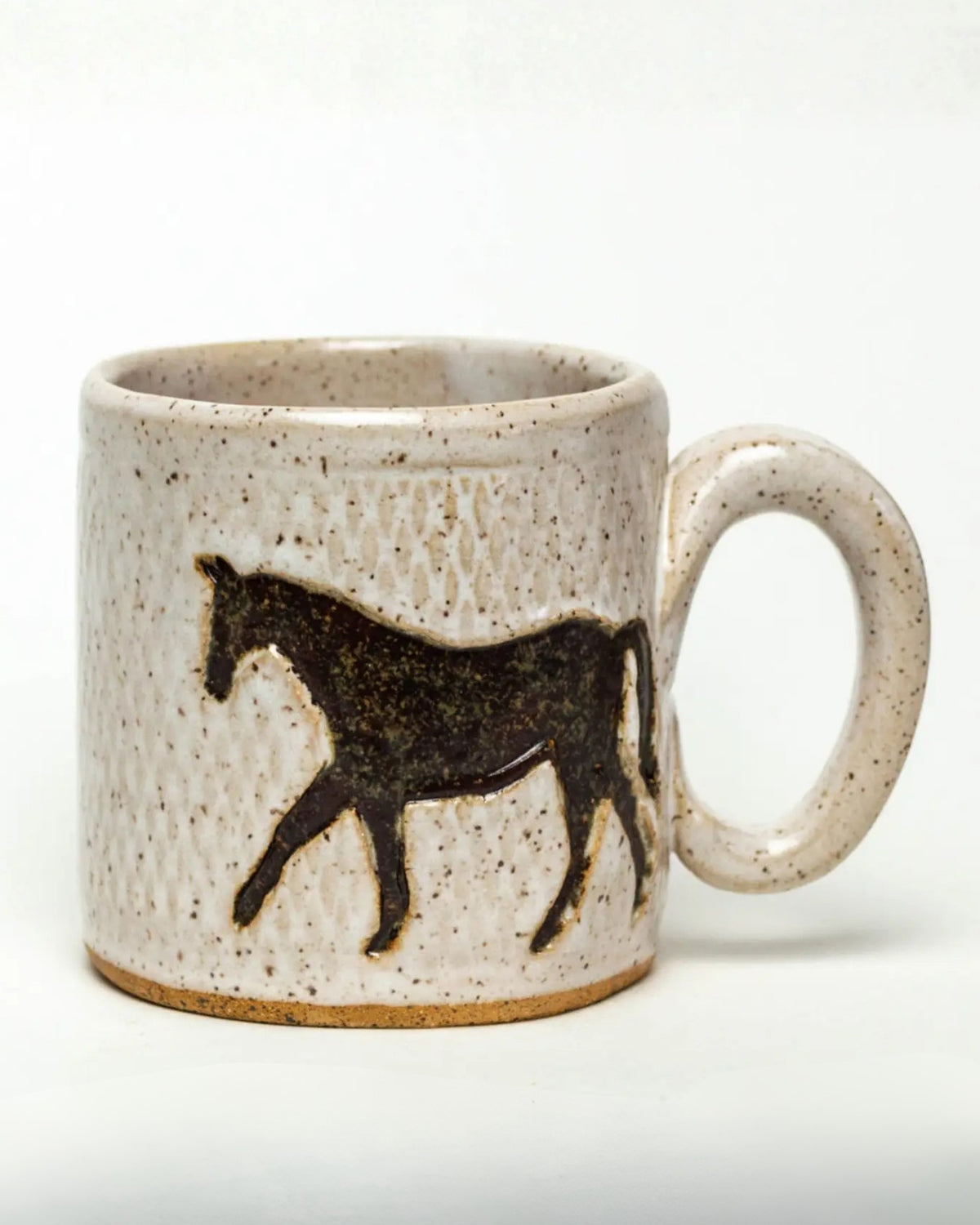 Ivory speckled ceramic mug with a dark horse design and handle on the right.