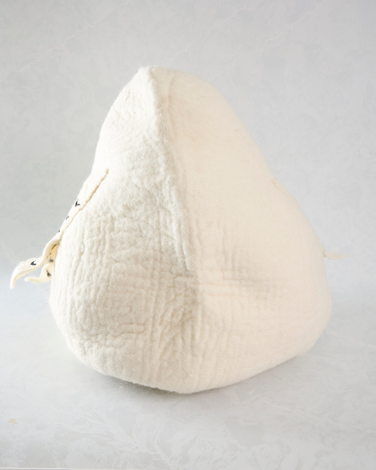 Back view of the ivory owl pet cave, showing the plain rear panel and stitched center seam.