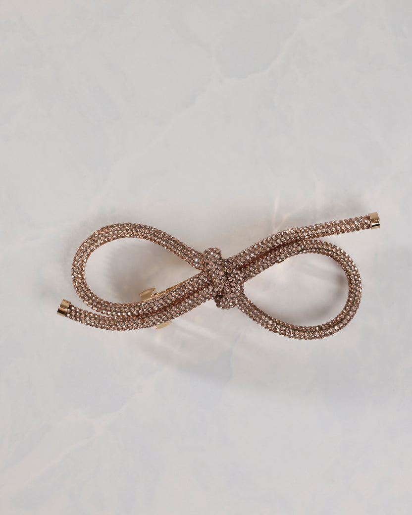 Gold sparkling bow barrette shown from the front
