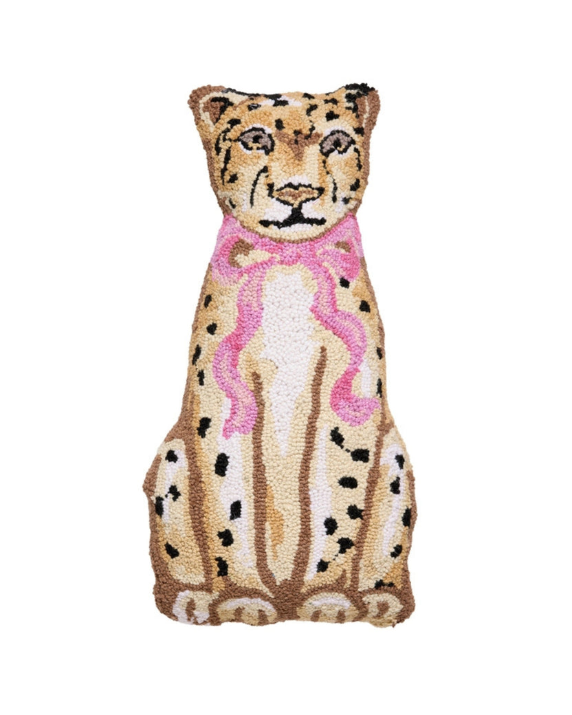 Front view of a hooked pillow depicting a seated spotted leopard wearing a pink bow.
