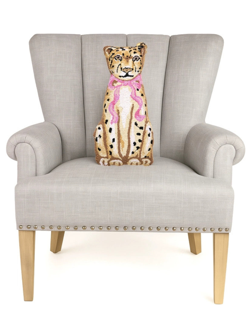 Leopard-design pillow displayed upright on a light gray armchair.