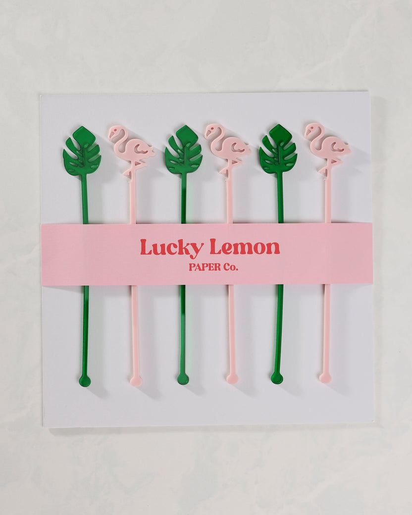 Packaged set of six pink flamingo and green palm-leaf stir sticks.