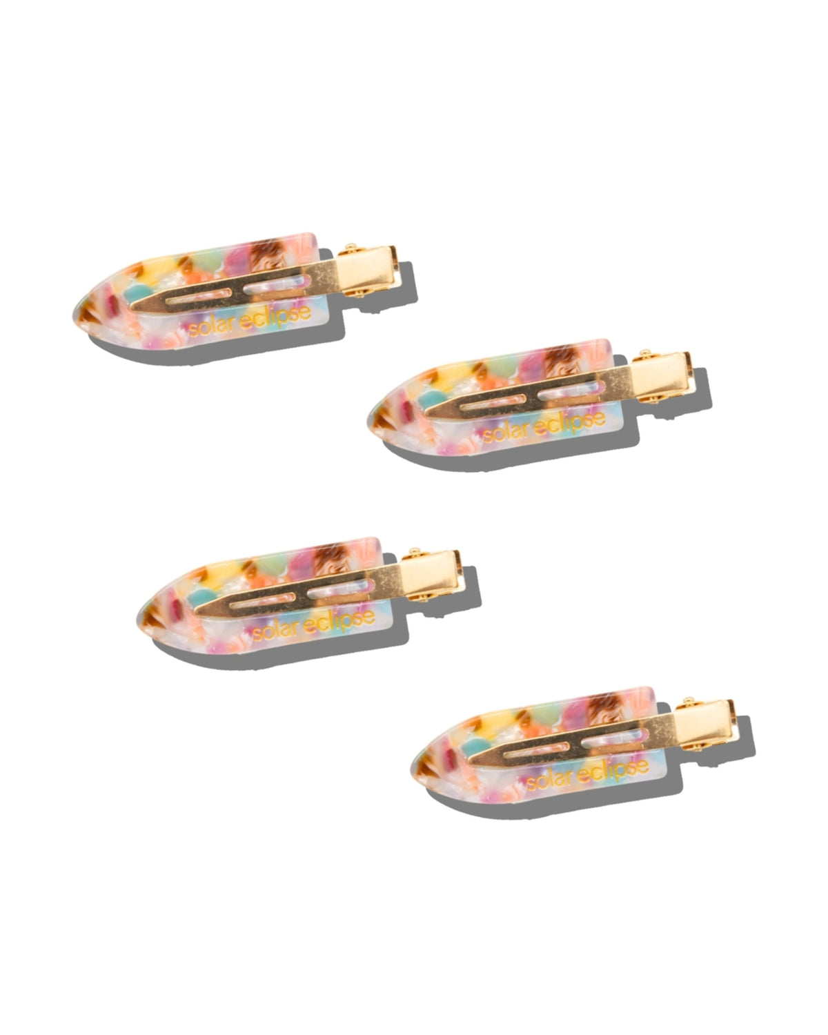Set of four multicolored hair clips with gold-tone metal fasteners