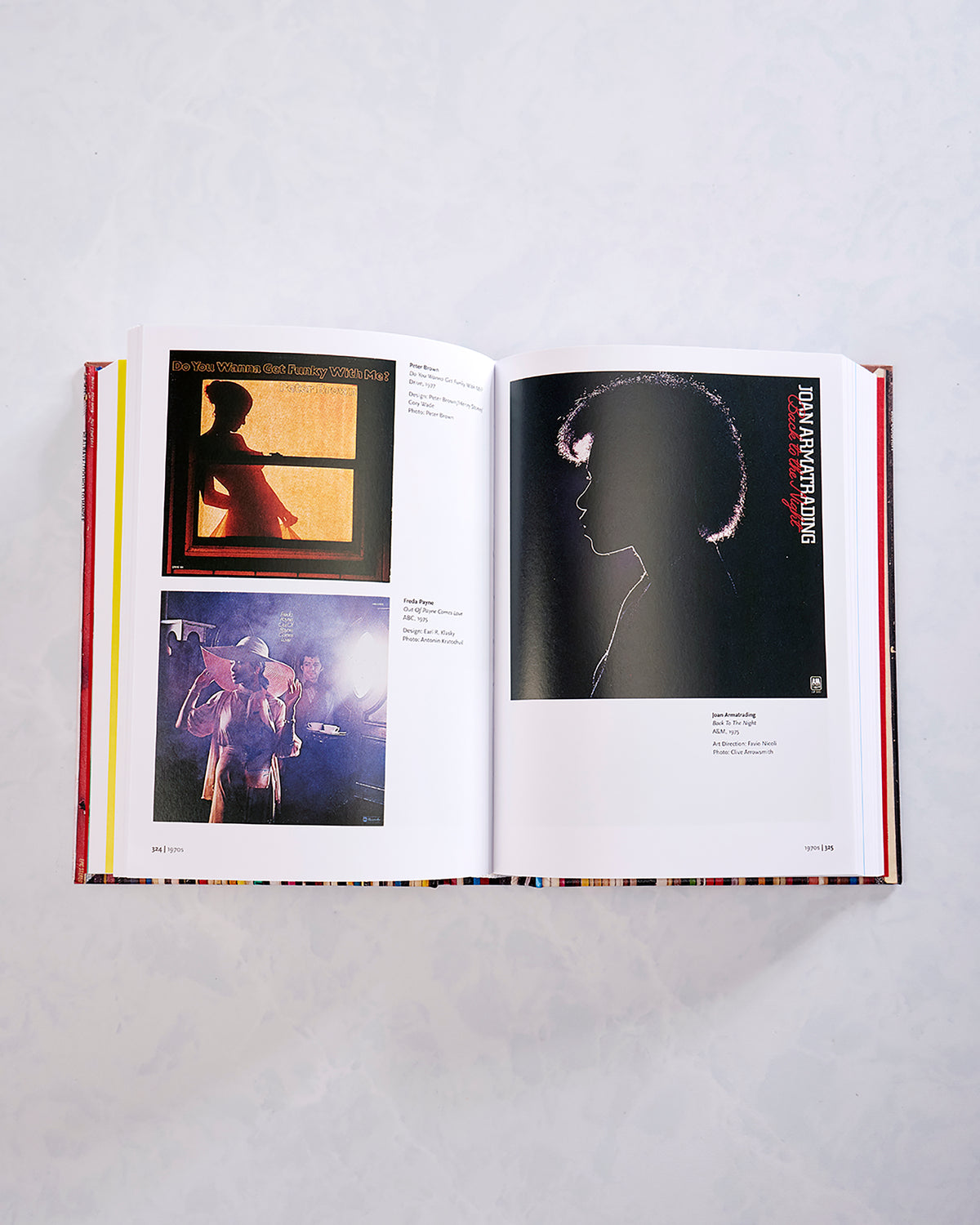 Open book spread showing two music-related images on the left page and a Joan Armatrading album cover on the right.