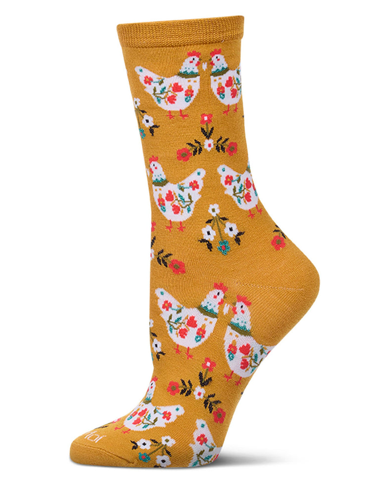 Single mustard crew sock with a repeating pattern of white floral chickens and small flowers.