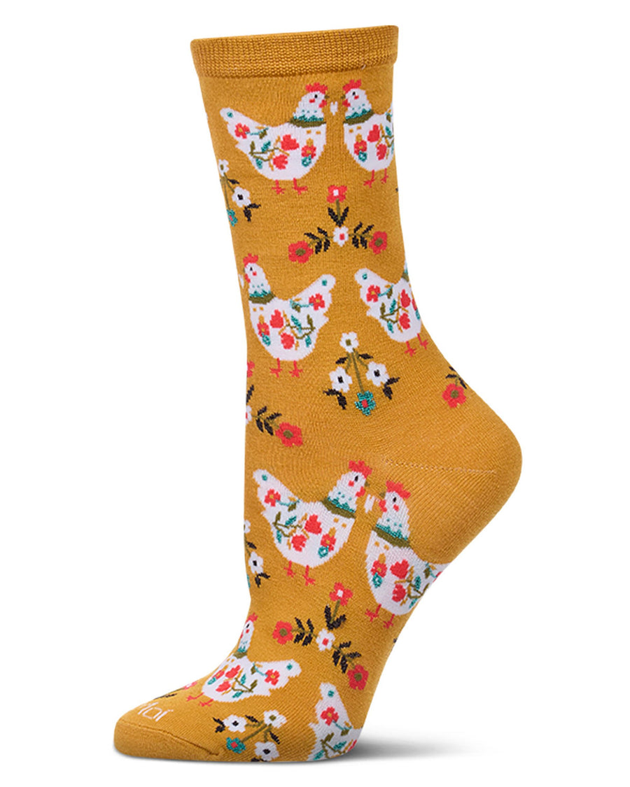 Single mustard crew sock with a repeating pattern of white floral chickens and small flowers.