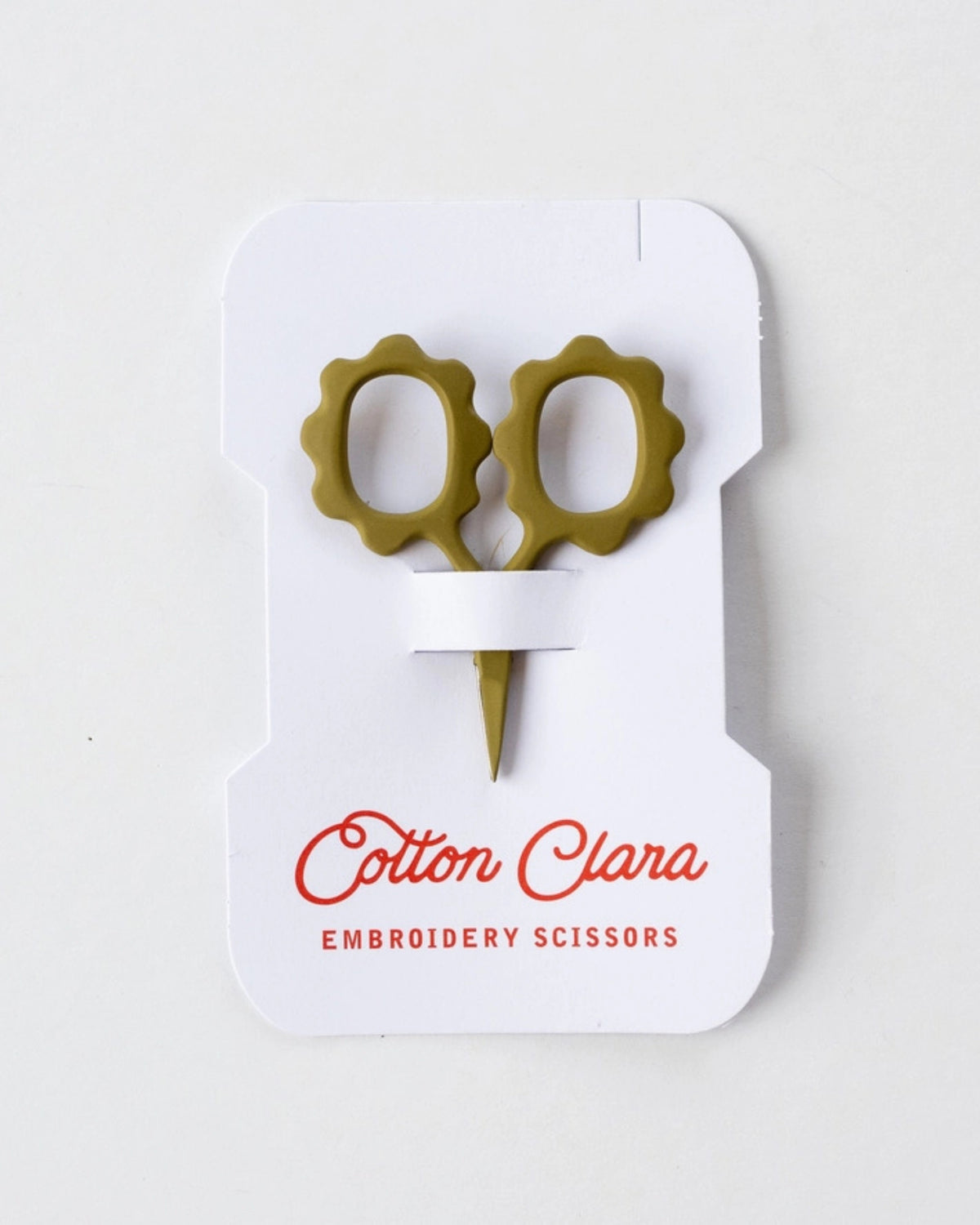 Front view of mini sunflower embroidery scissors in olive green on Cotton Clara product packaging.