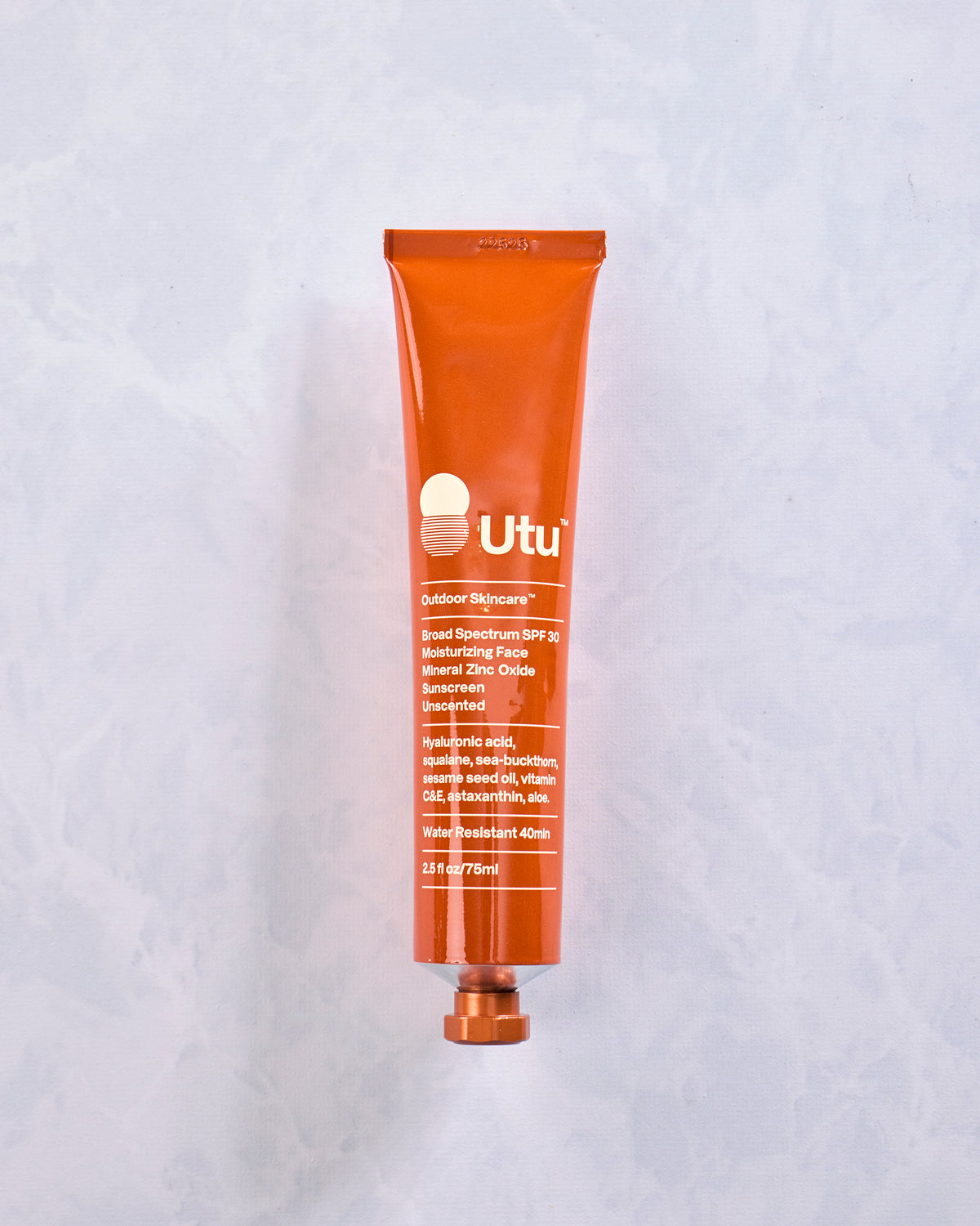 Front view of an orange Utu Outdoor Skincare SPF 30 sunscreen tube.