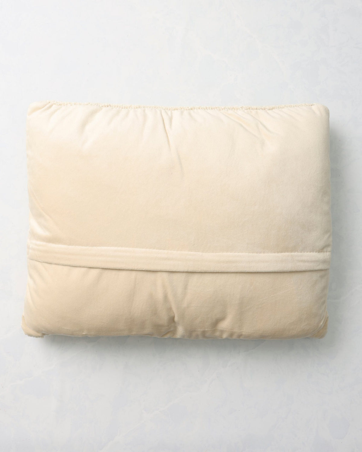 Back of the caroling cats pillow with a plain light-colored backing.