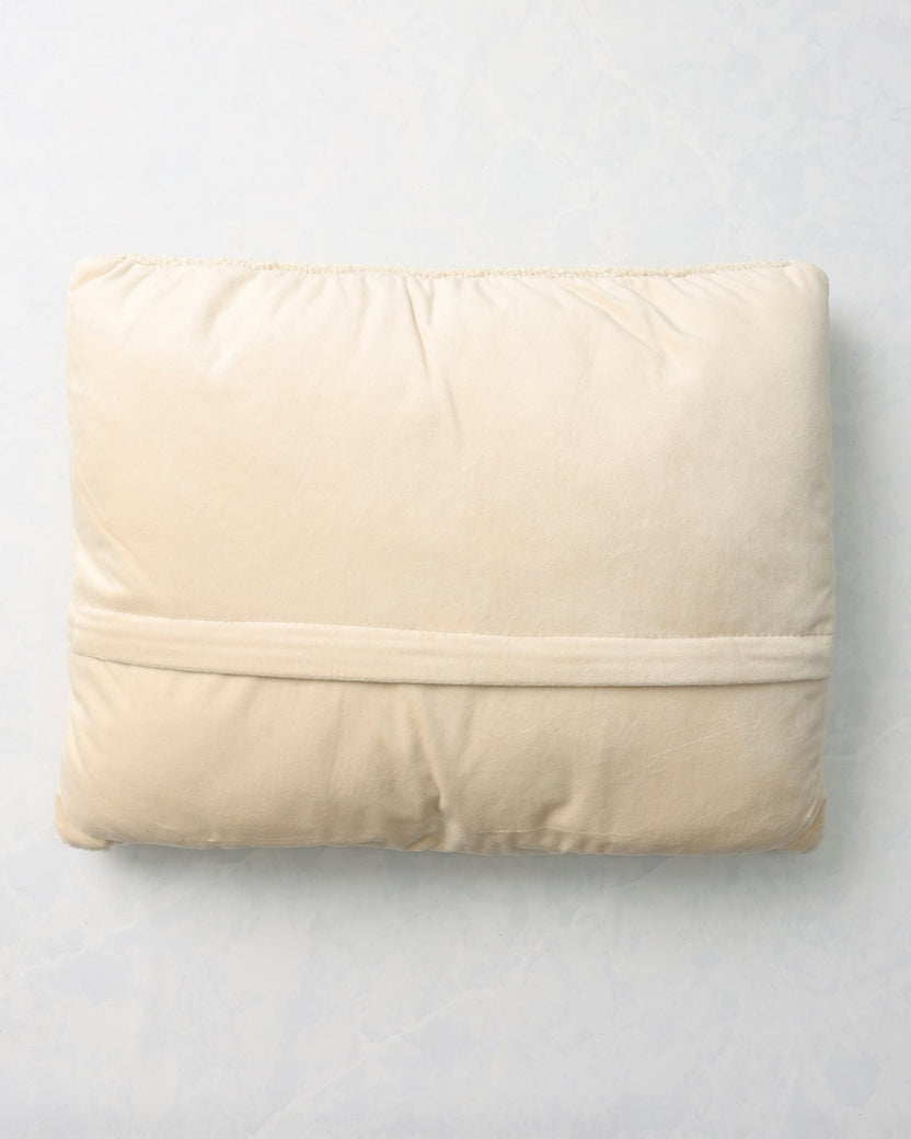 Back of the caroling cats pillow with a plain light-colored backing.