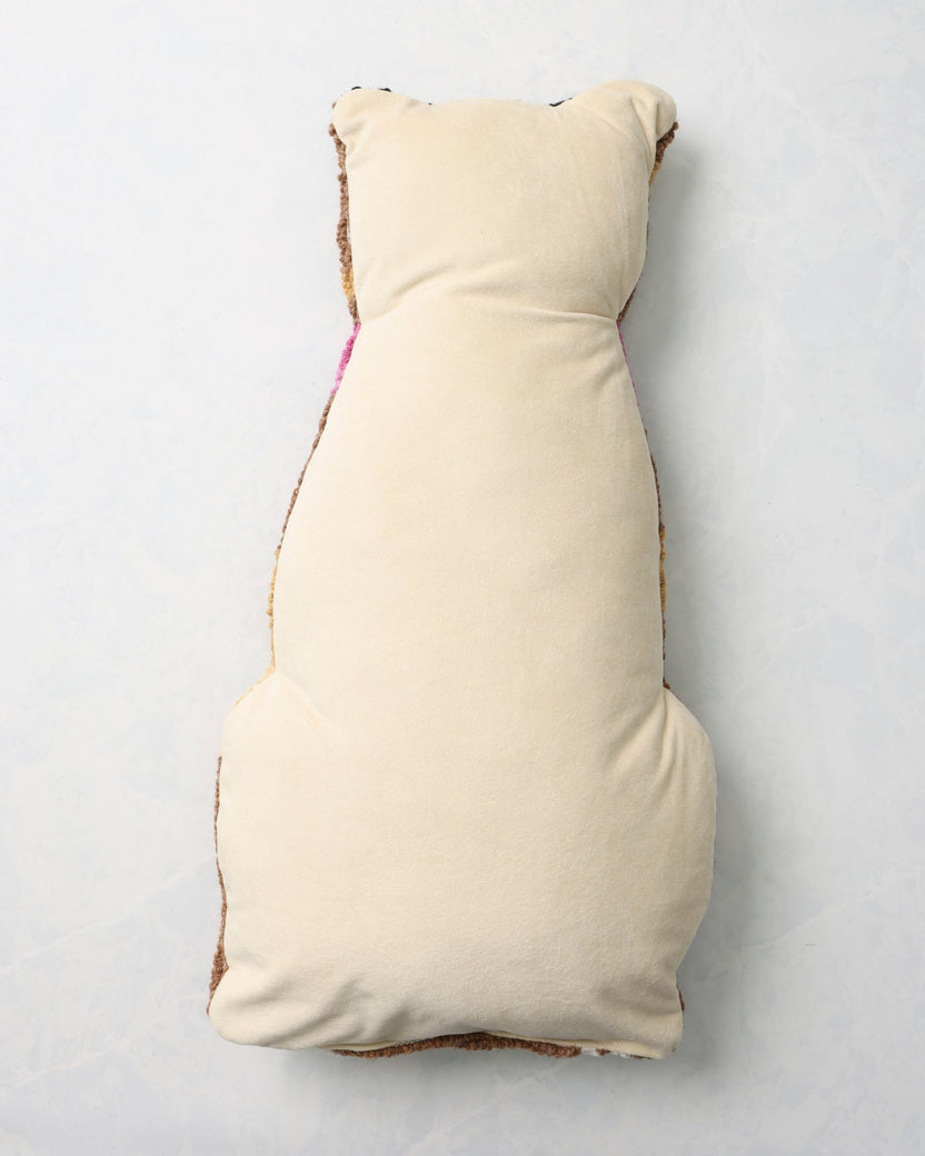 Back of the leopard pillow with a plain light-colored backing.