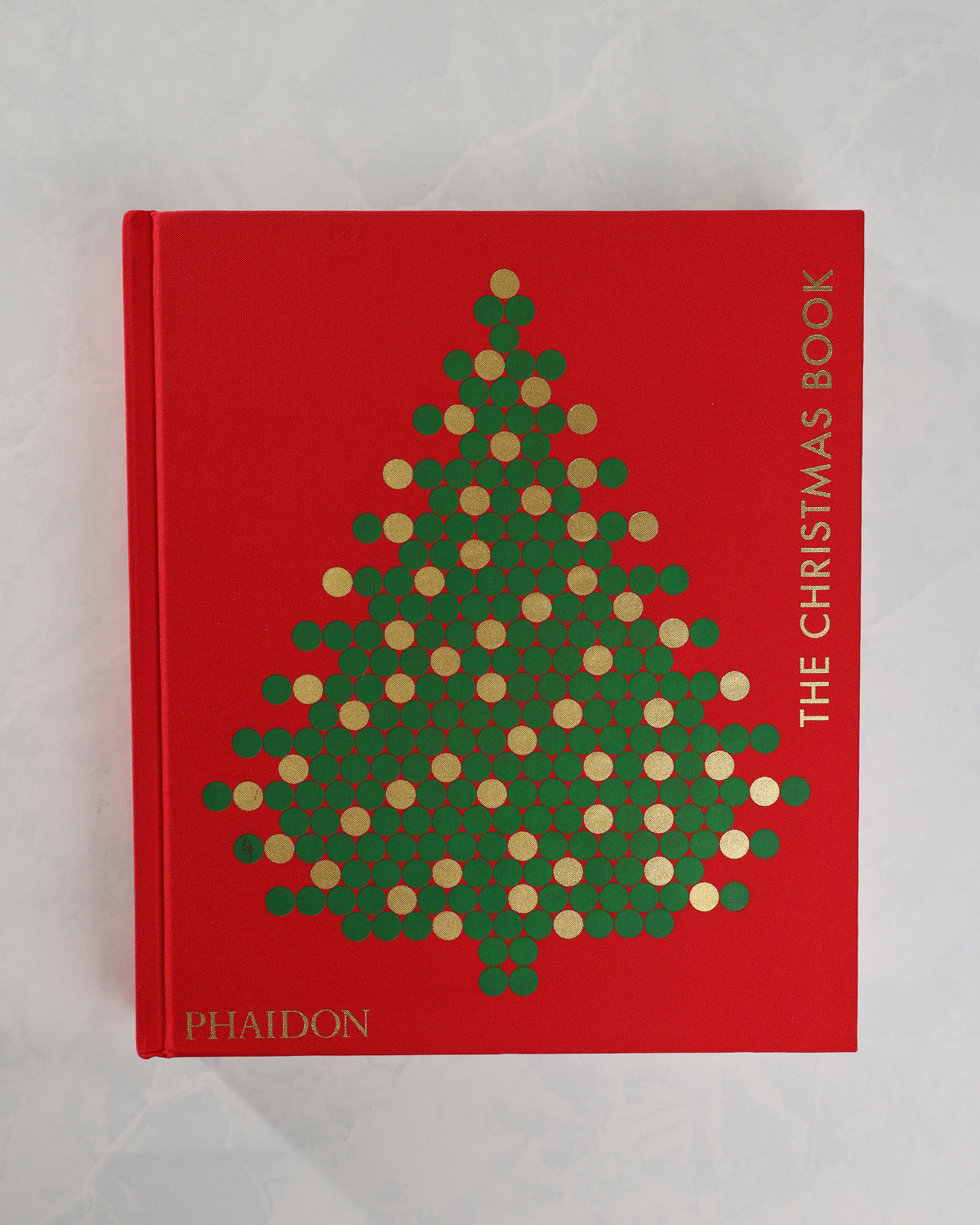 Front cover of The Christmas Book by Phaidon, in red with a green-and-gold Christmas tree design and vertical gold title lettering.