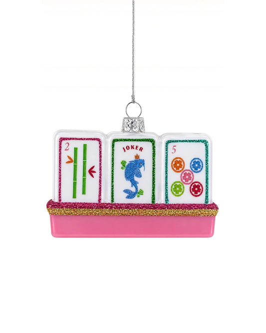 Glass mahjong tile ornament with three illustrated tiles, including tiles marked 2, JOKER, and 5, on a pink glitter-trimmed base.