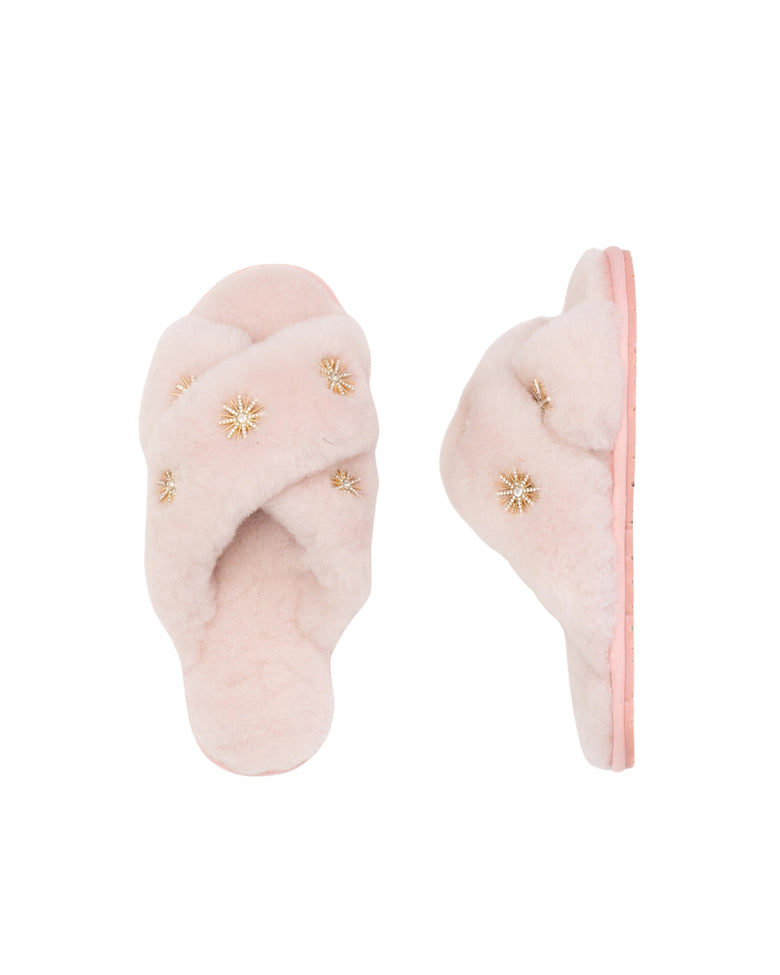 Pink open-toe slippers with crossed plush straps and rhinestone embellishments, shown from above and the side.