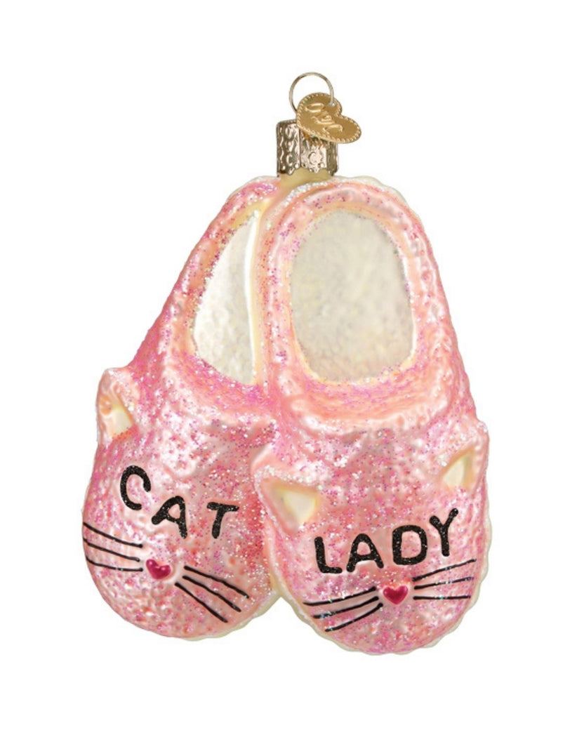 Front view of a pink glitter slipper ornament shaped like a pair of cat-faced slippers, with a hanging loop and “CAT LADY” text.