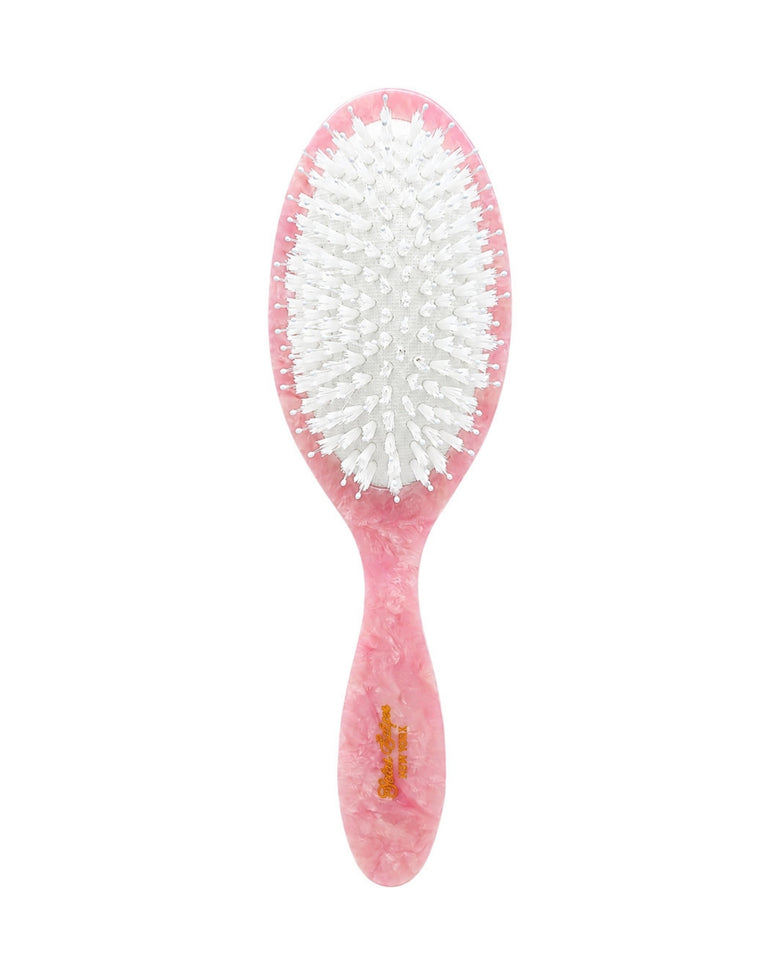 Front view of the pink brush, showing its white bristles and pink handle.