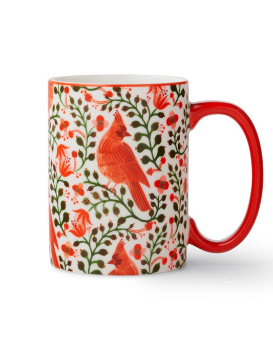 White porcelain mug with red handle and rim, decorated with red cardinal illustrations and green botanical motifs.