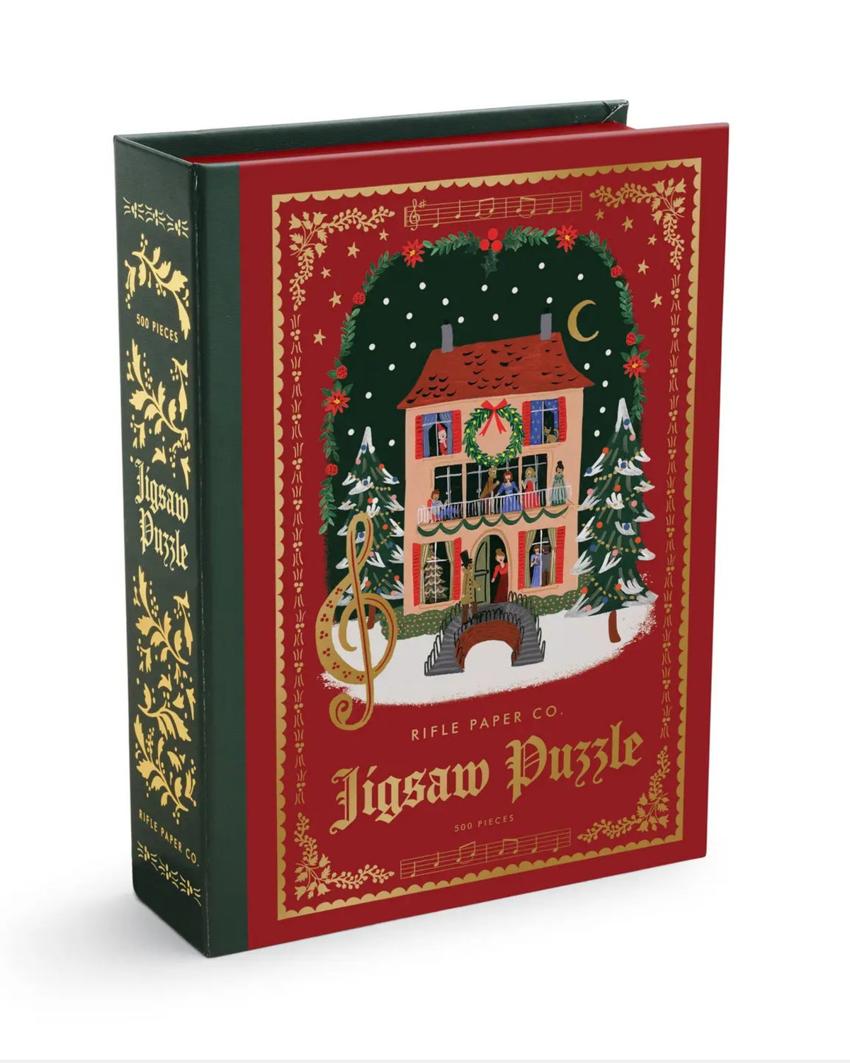 Book-shaped box for a 500-piece Christmas carol jigsaw puzzle, illustrated with a decorated house, Christmas trees, and musical motifs.