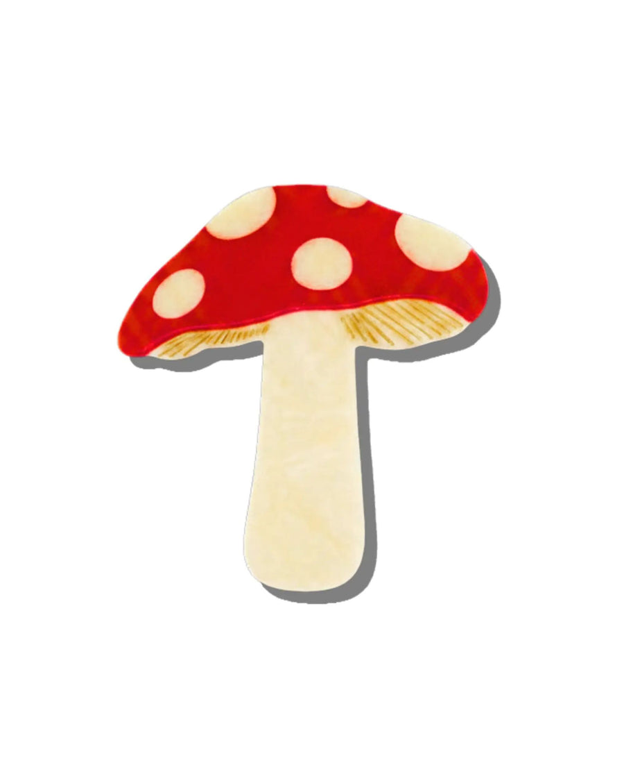 Hand-painted red mushroom claw hair clip shown from the front, with cream spots and a cream stem.