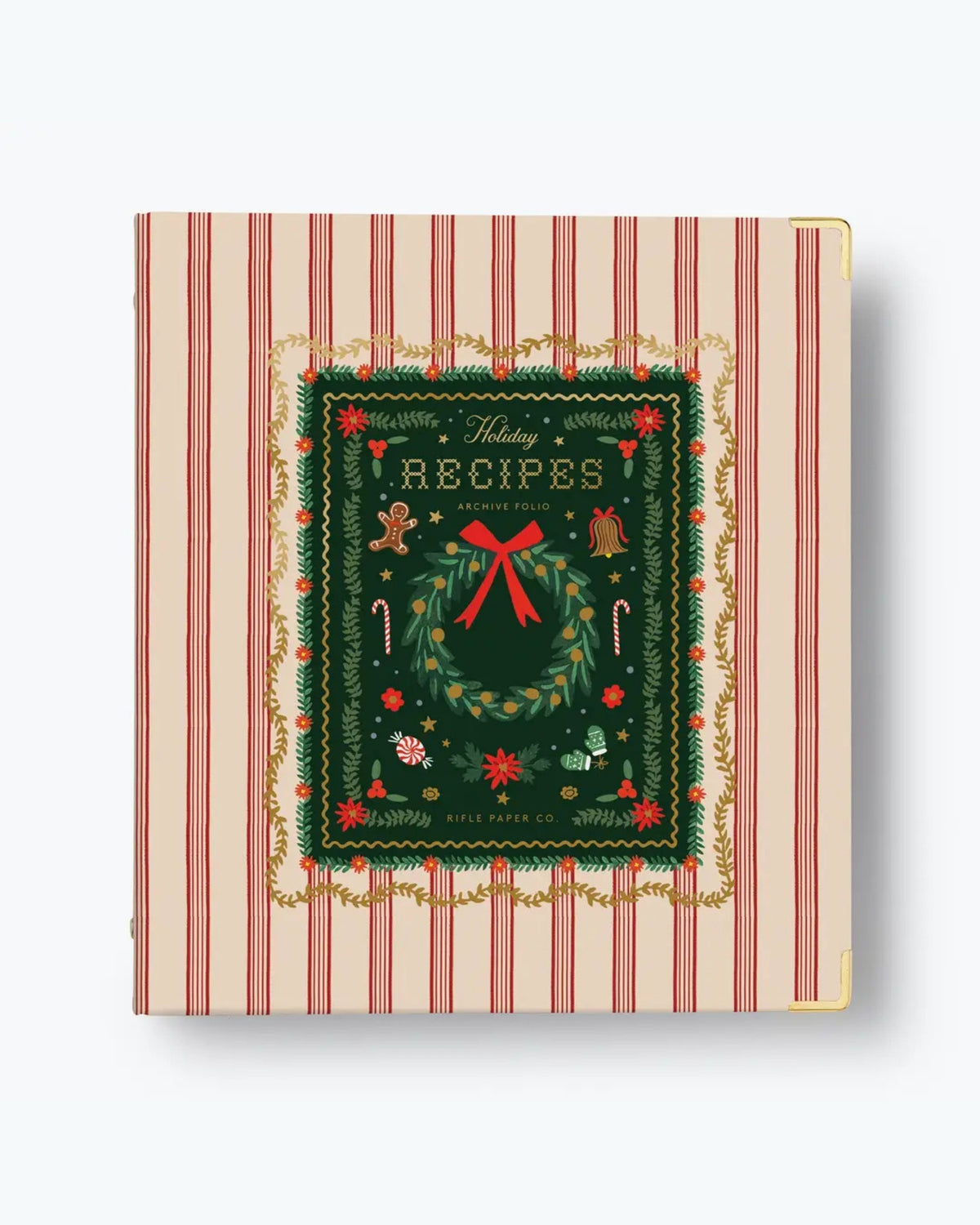 Closed red-striped holiday recipe binder with an illustrated wreath cover and gold-tone corner protectors.