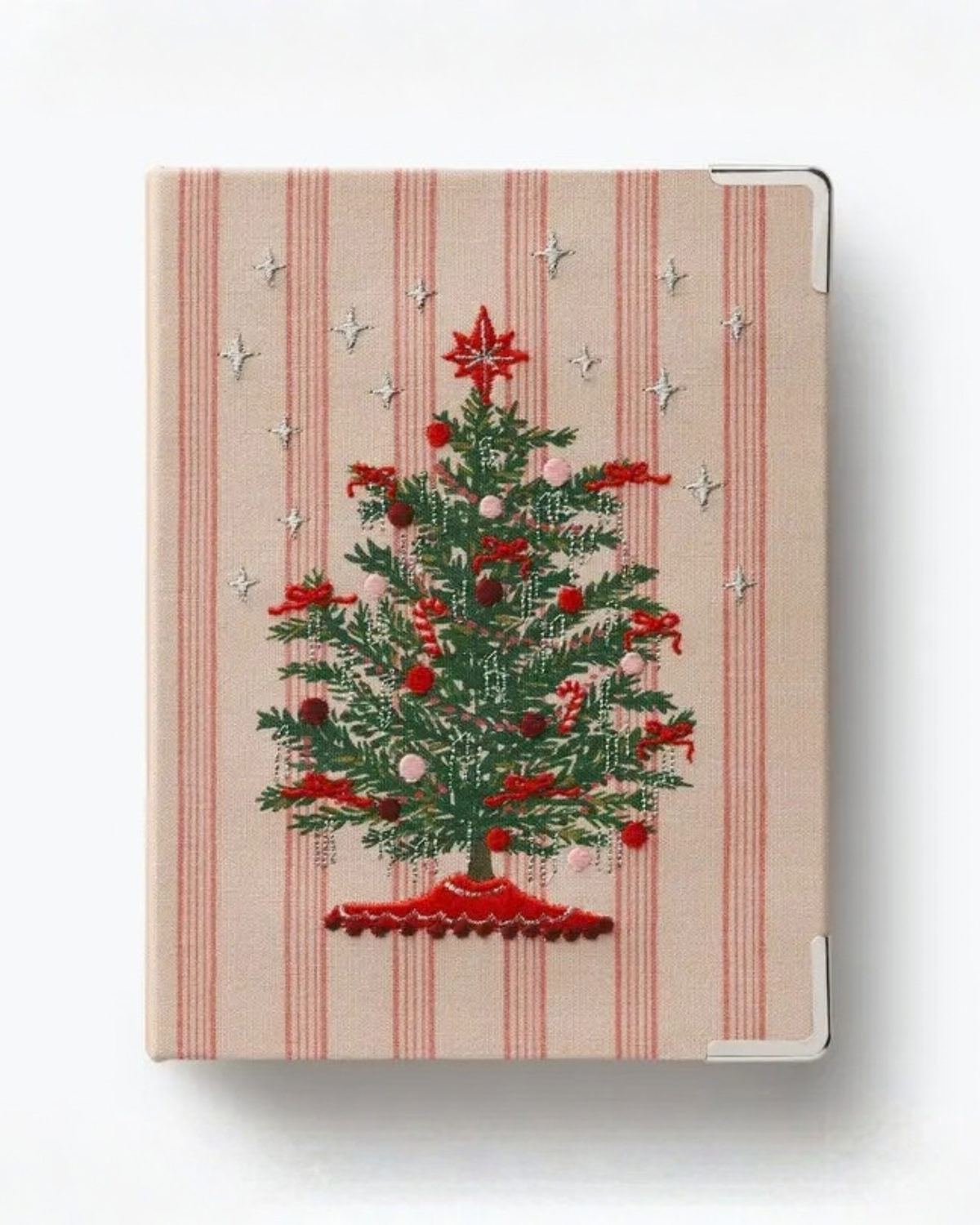 Closed small photo album with a red-striped cover, embroidered decorated Christmas tree, star details, and metal corner protectors.
