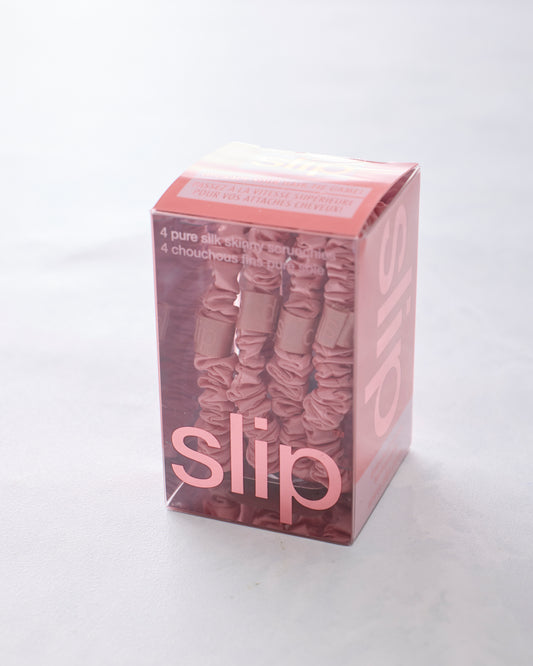Box of four rose skinny scrunchies by Slip in a clear pink package.