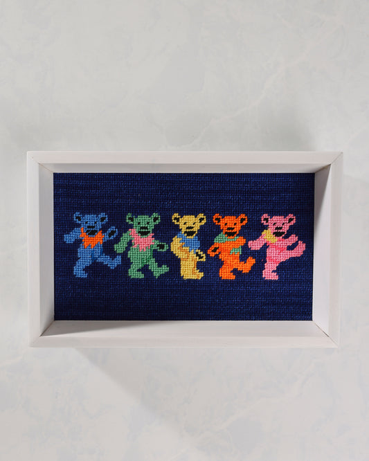 Dark navy valet tray with a white frame and a stitched design of five colorful dancing bears.