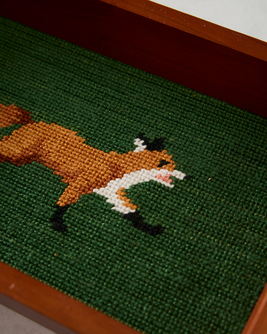 Close-up of the stitched orange and white fox design on the dark green valet tray inlay.