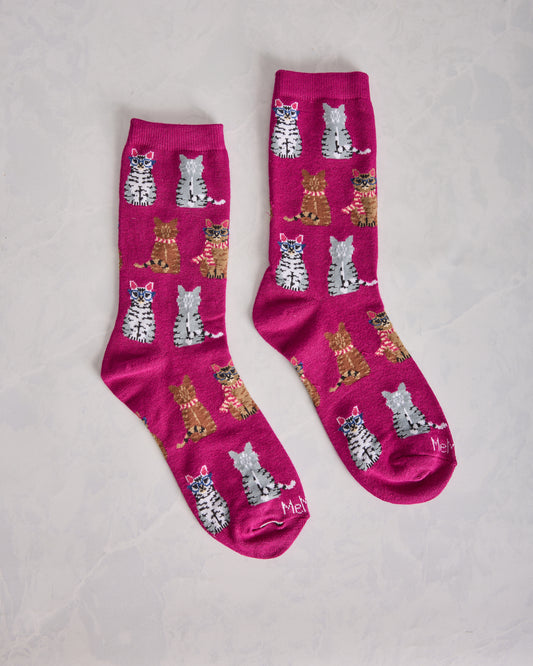 Pair of fuchsia crew socks covered with repeating cat illustrations.