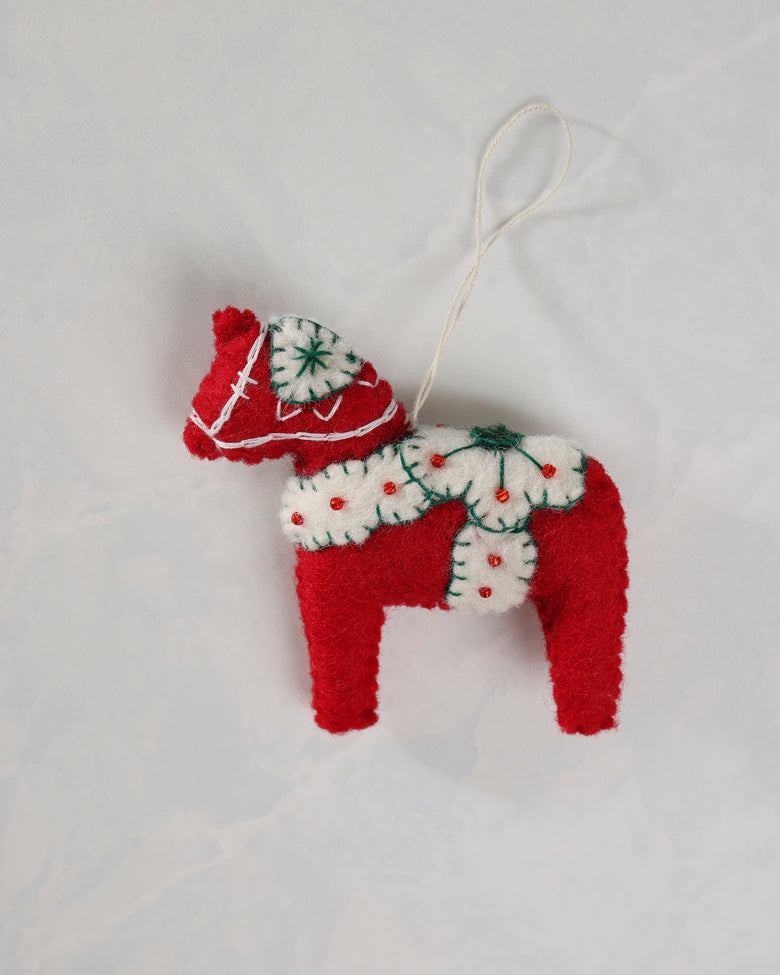Red and ivory dala horse ornament with a hanging loop