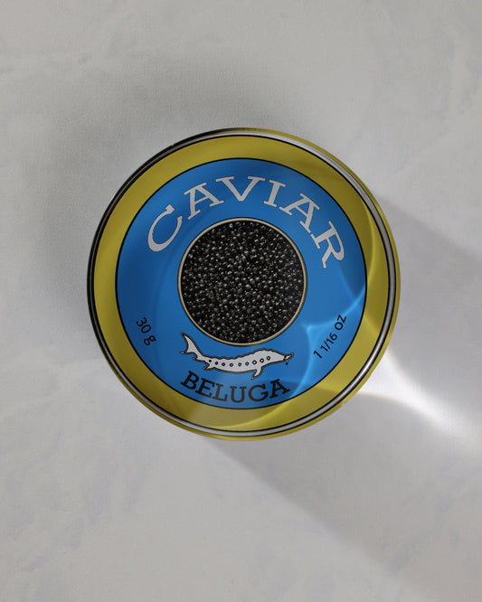 Top view of a round blue-and-gold caviar-themed napkin weight labeled Beluga.