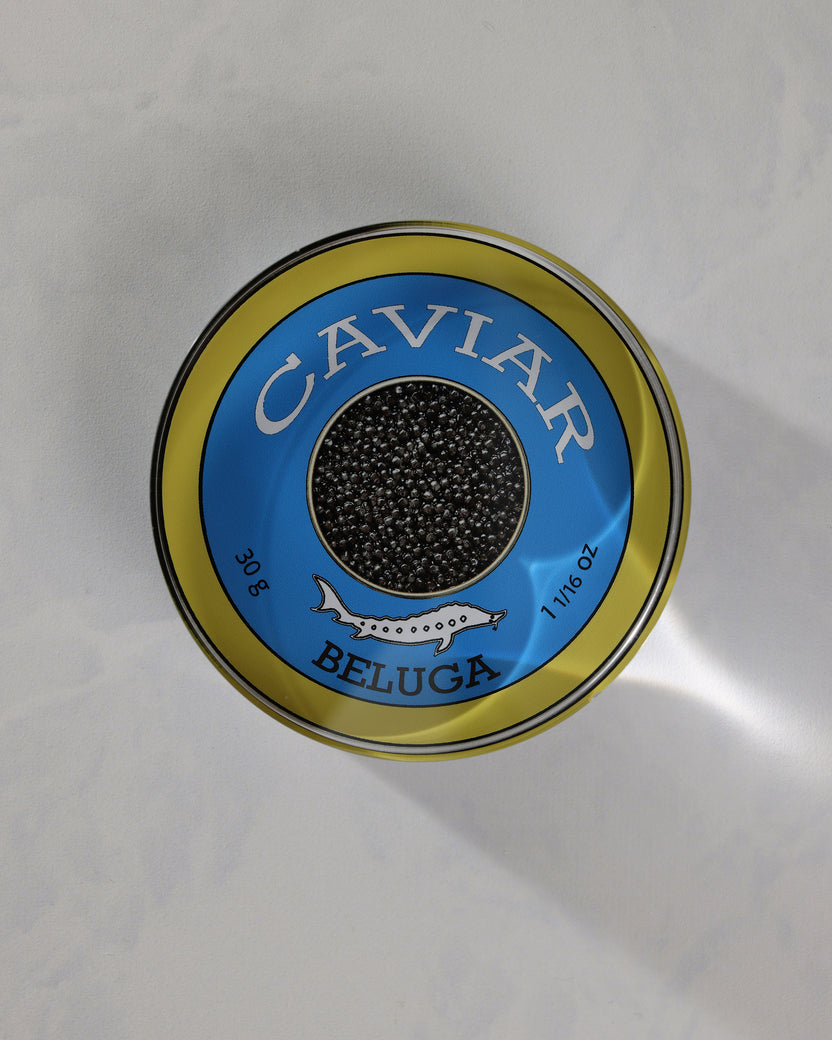 Top view of a round blue-and-gold caviar-themed napkin weight labeled Beluga.