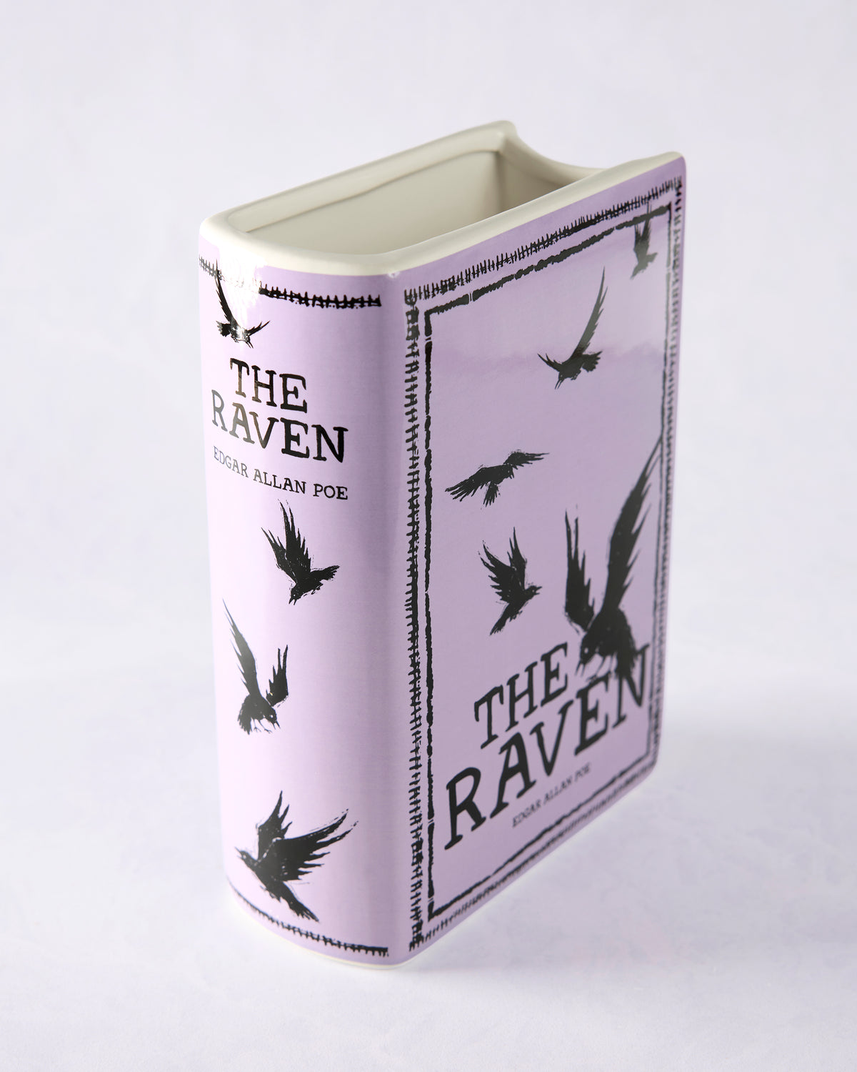 Purple book-shaped vase with black raven illustrations and cover-style text for Edgar Allan Poe’s “The Raven.”