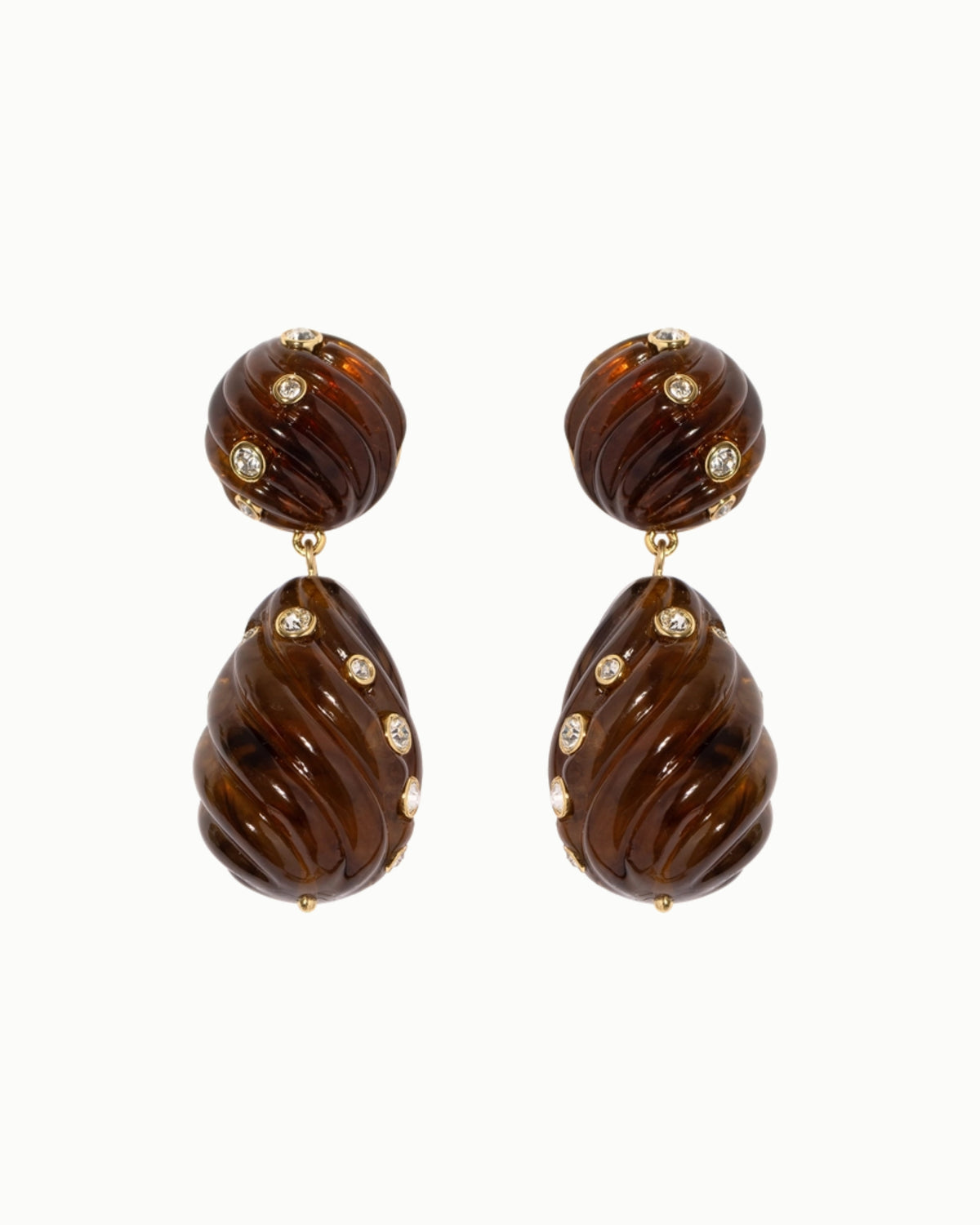 Pair of tortoise drop earrings with brown ridged oval pieces and small clear stones on a white background.