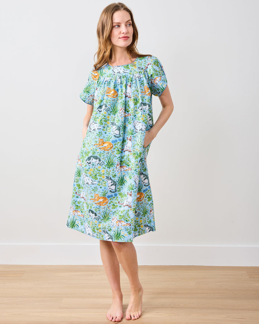 Full-length view of the Retro Dreams nightgown in a light blue cat-and-floral print, with short sleeves and side pockets.