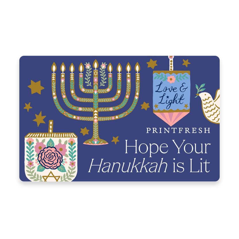 Illustrated blue gift card featuring a menorah and the message “Hope Your Hanukkah is Lit.”